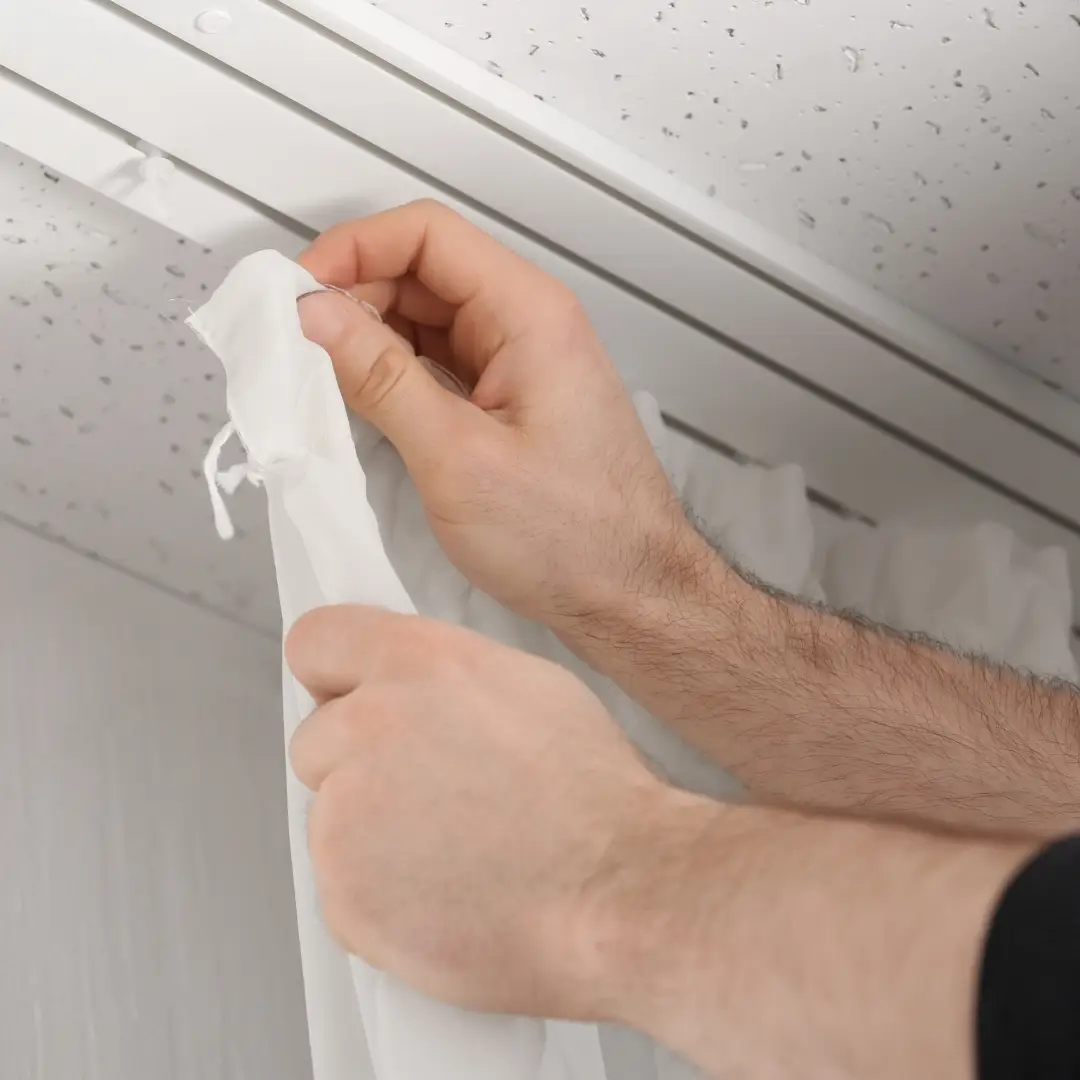 Expert curtain fixer installing curtains in Abu Dhabi apartment